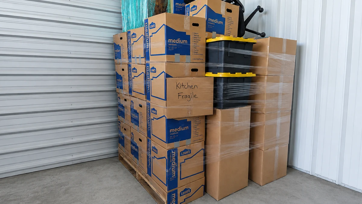 Palletized and shrink-wrapped household goods stacked in Matthew & Mois storage