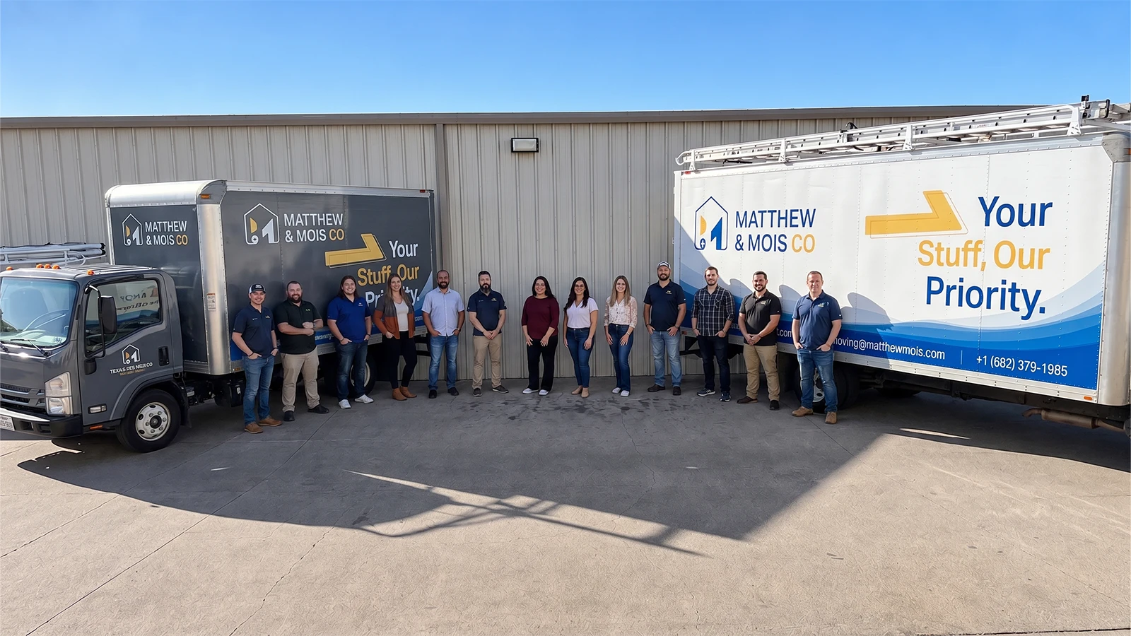 The Matthew and Mois team lined up between two of the company's branded box trucks outside the warehouse